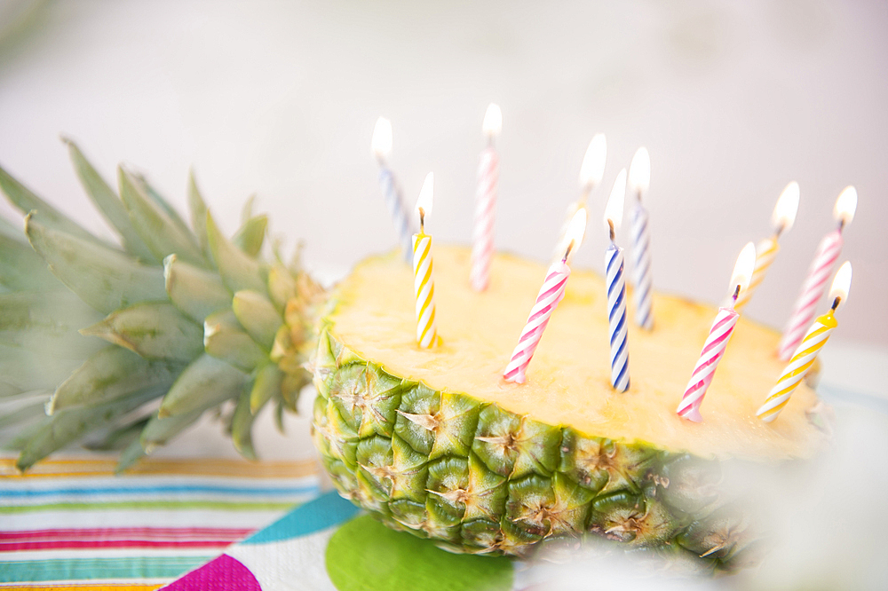 Candles burning in half of sliced pineapple