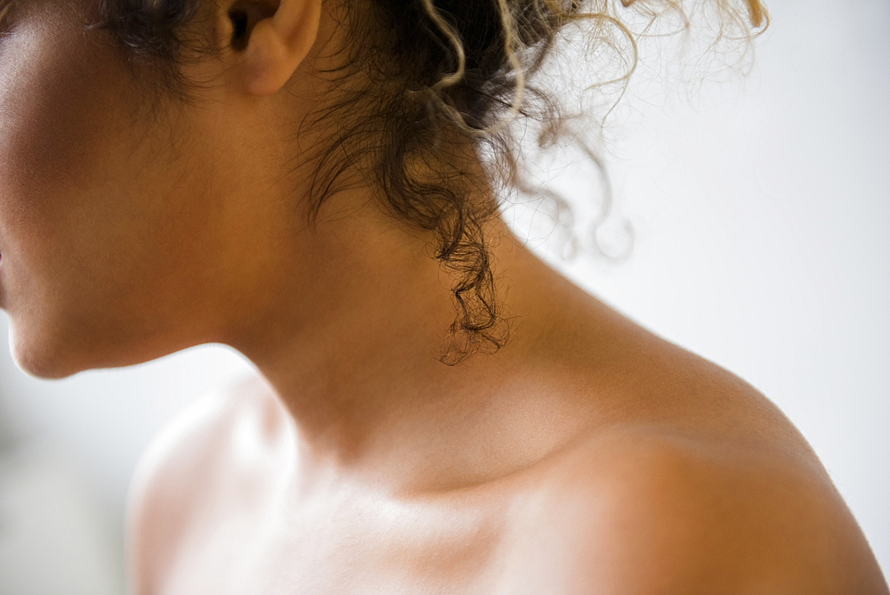 Neck and bare shoulders of Mixed Race woman