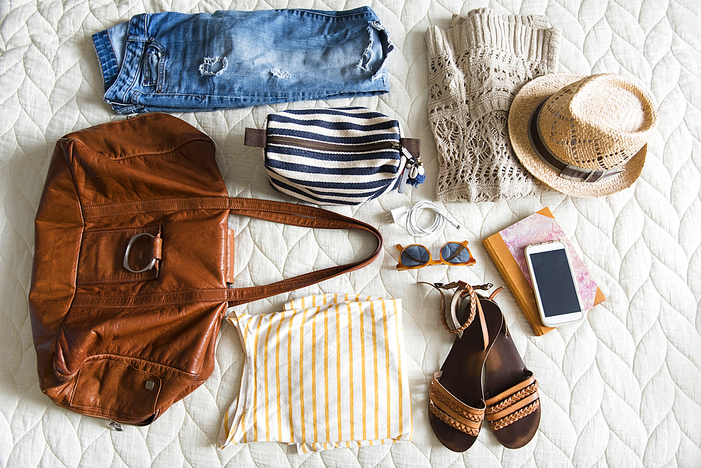 Summer travel clothing of woman on blanket