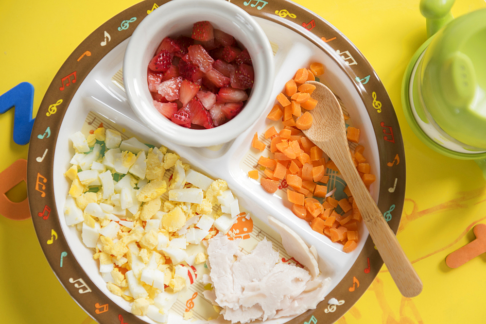 Baby food and spoon on plate