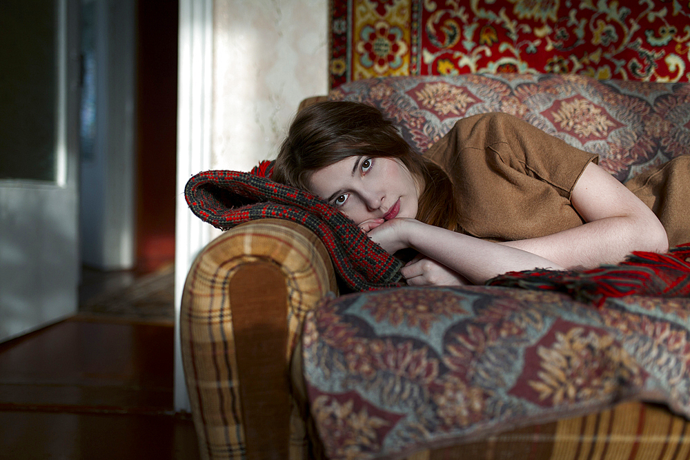 Caucasian woman laying on sofa