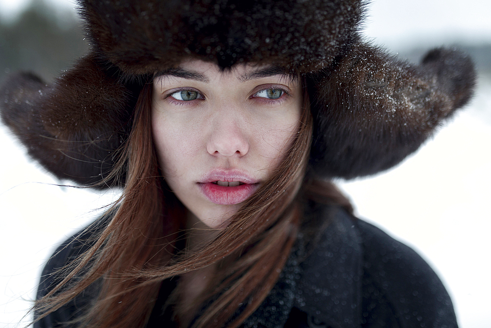 Serious Caucasian woman wearing fur hat and coat in winter