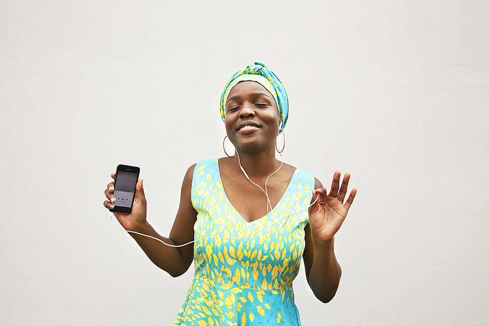 Black woman dancing to music on cell phone