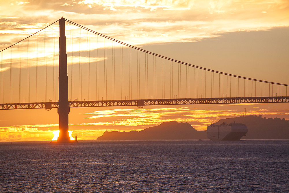 Silhouette of bridge over water at sunset