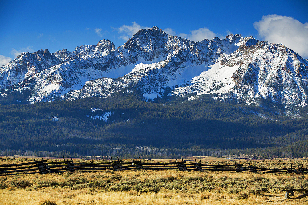 Wooden fence near snowy mountain