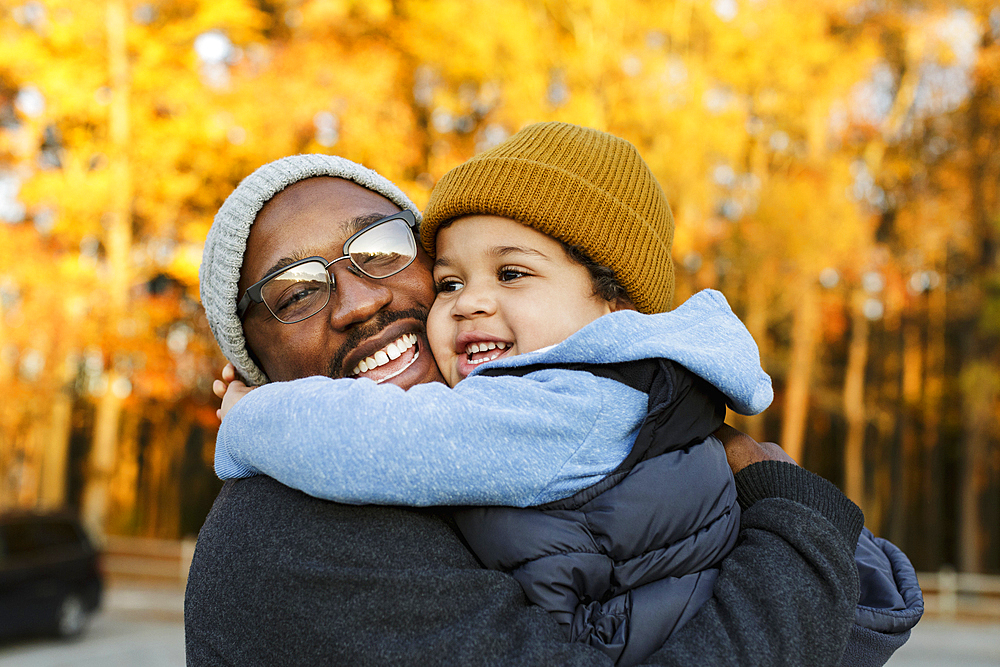 Father and son hugging in park