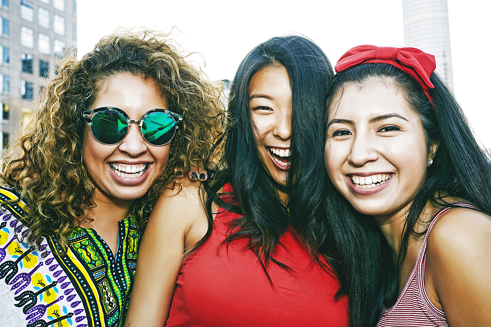 Portrait of women smiling on urban rooftop