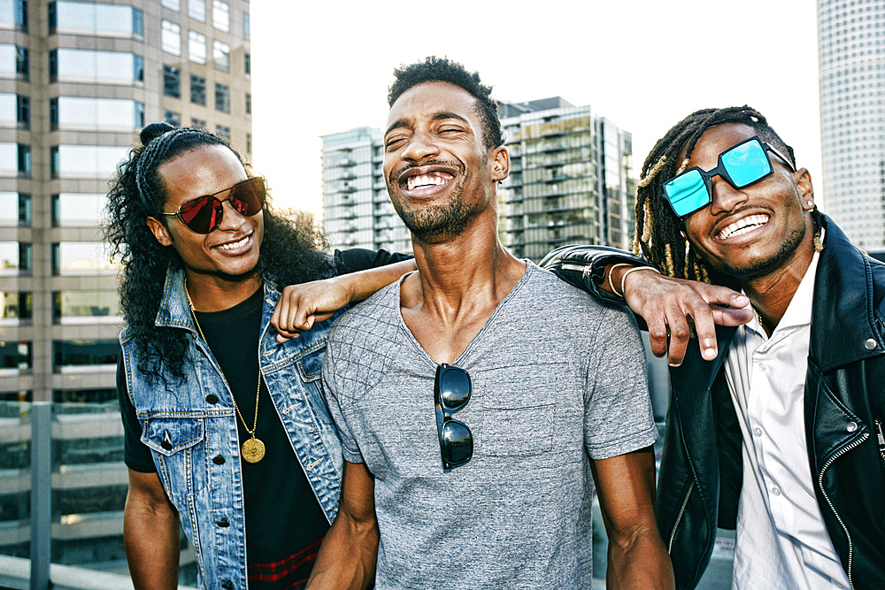 Portrait of men smiling on urban rooftop