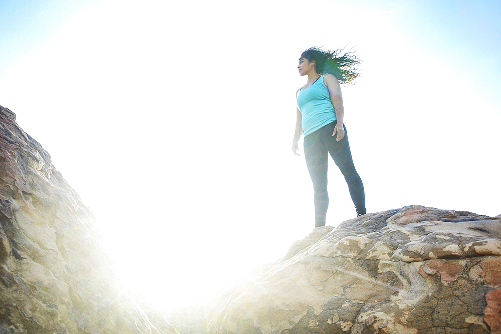 Mixed Race woman standing on rock