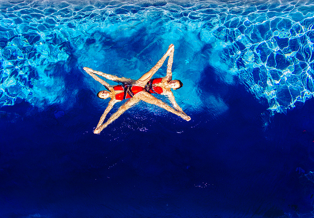 Aerial view of Caucasian synchronized swimmers