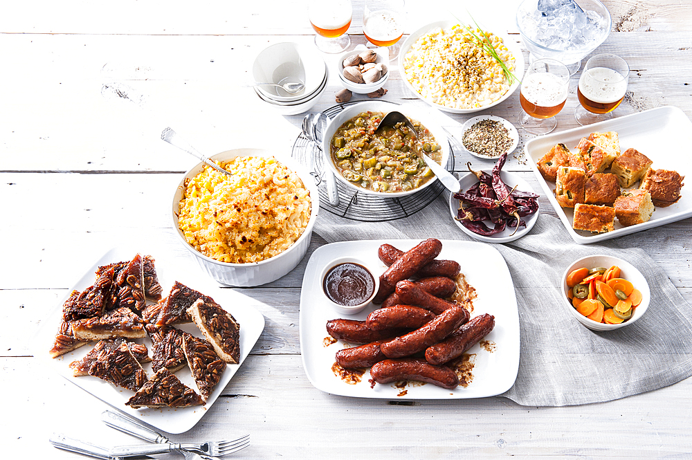 Plates of food and beer on wooden table