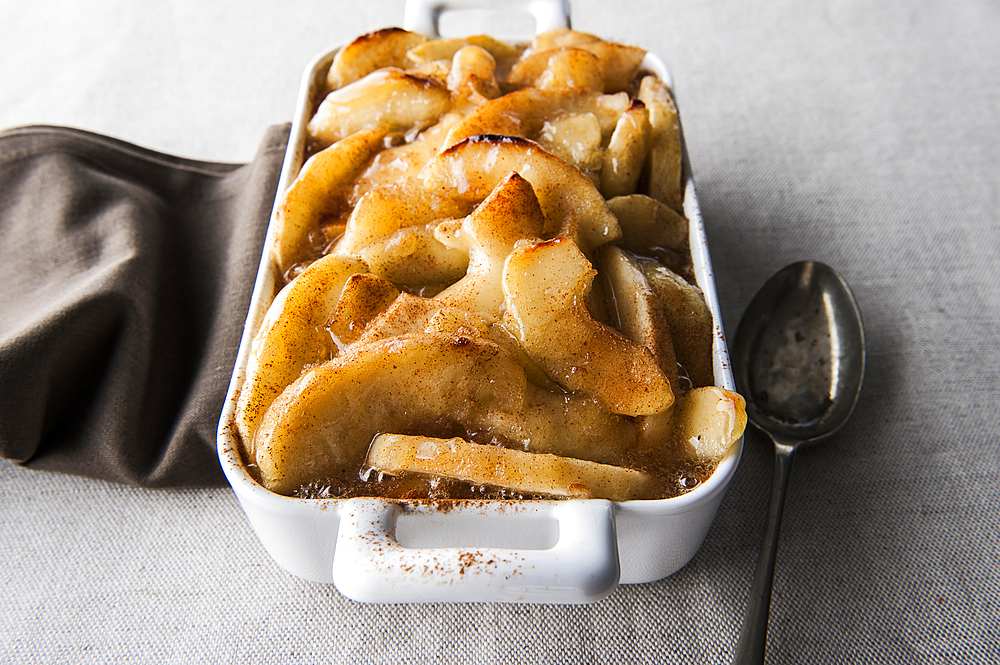 Tray of baked apples with spoon