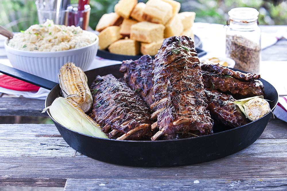 Pan of barbecue ribs on wooden table