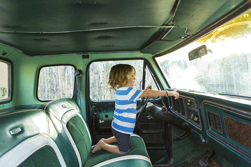 Caucasian boy playing in truck