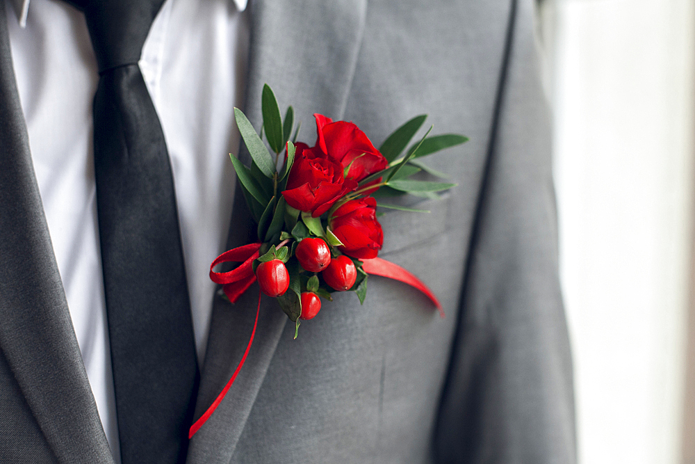 Red corsage on suit jacket