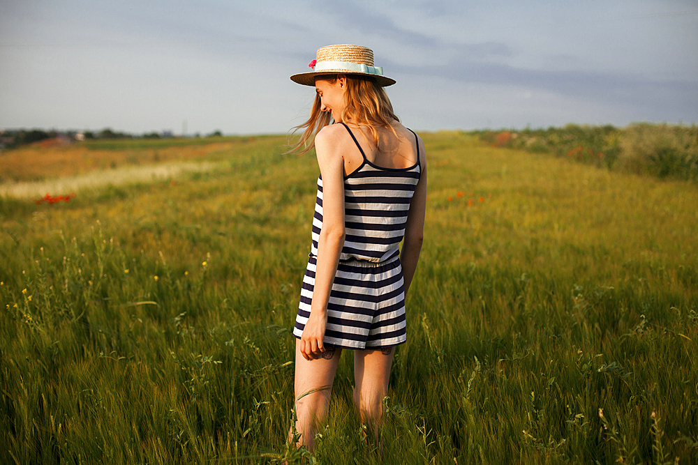 Caucasian woman standing in field of tall grass