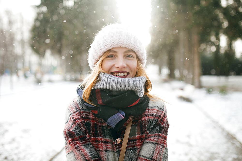 Caucasian woman smiling in snow