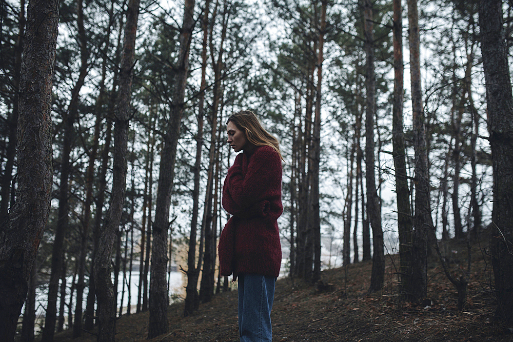 Caucasian woman standing near trees