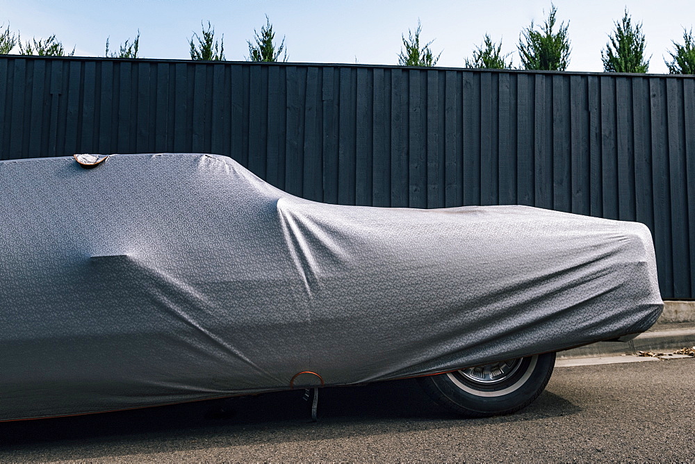 Protective cover on car near fence