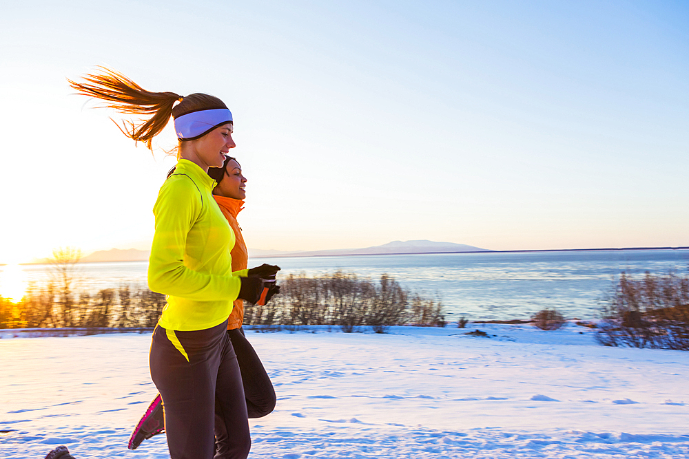 Women running on snow in winter