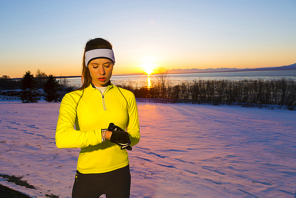 Caucasian woman checking the time on wristwatch in winter