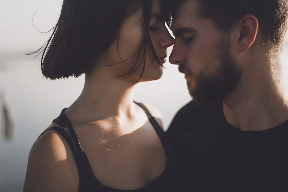 Caucasian couple face to face with eyes closed