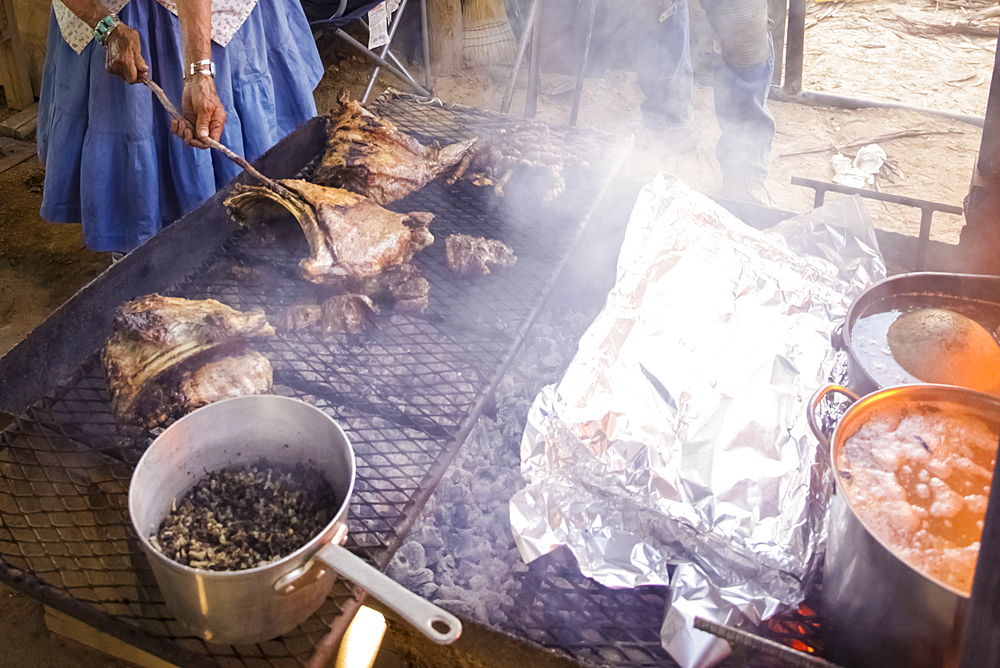 Woman cooking food on smoking grille