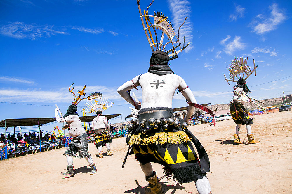 Apache men dancing in traditional regalia