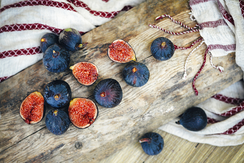 Sliced figs on wooden log