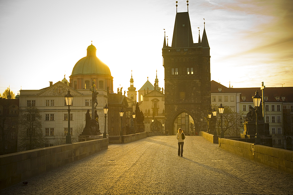 Distant woman standing on bridge in Prague, Czech Republic