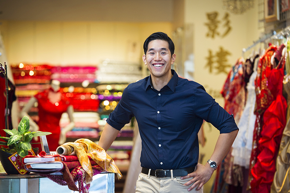 Smiling Chinese man posing in store