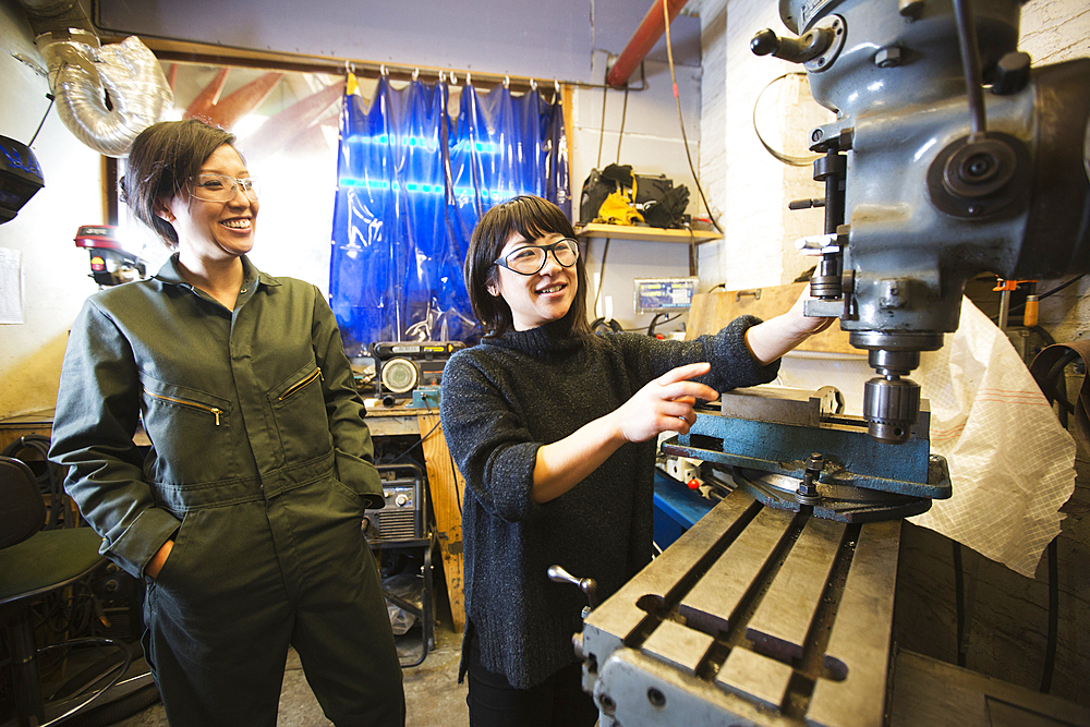 Women using machinery in workshop