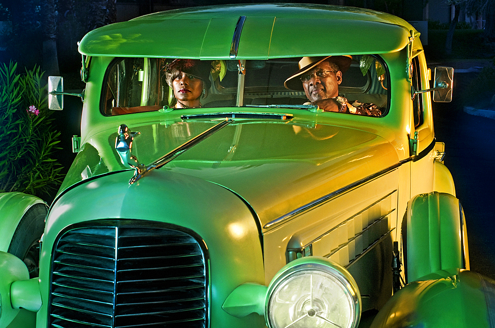 Couple in green vintage car