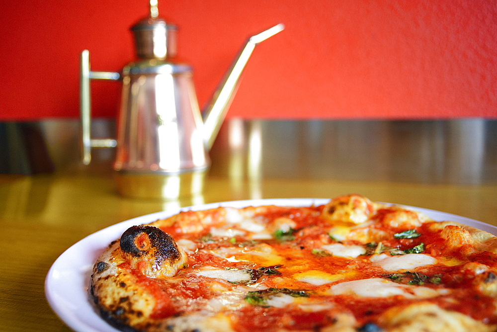 Pizza on plate in pizzeria