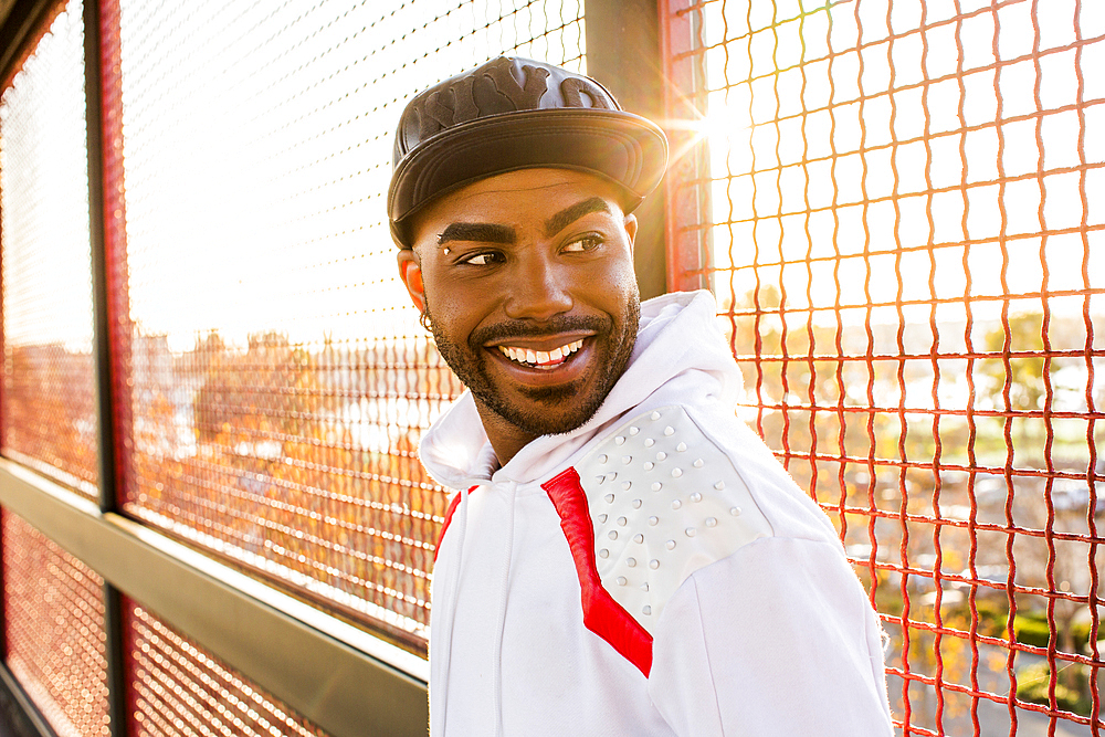 Smiling Black man near fence