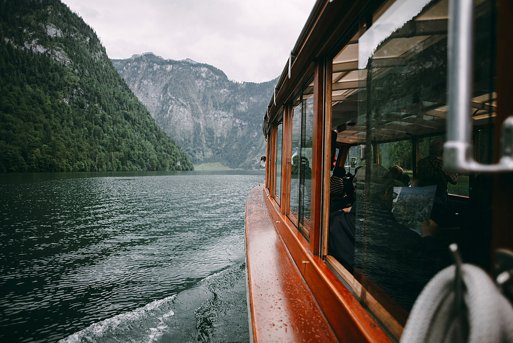 Close up of ferry on river near mountains