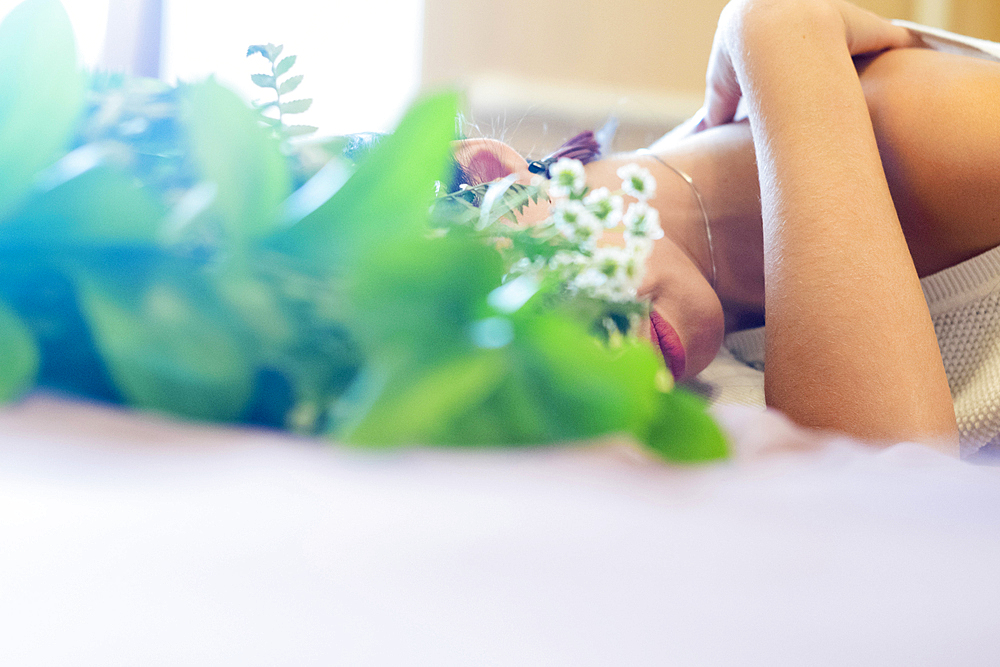 Face of Caucasian woman obscured by roses