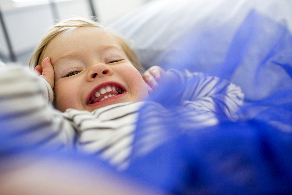 Laughing Caucasian baby girl wearing blue tutu