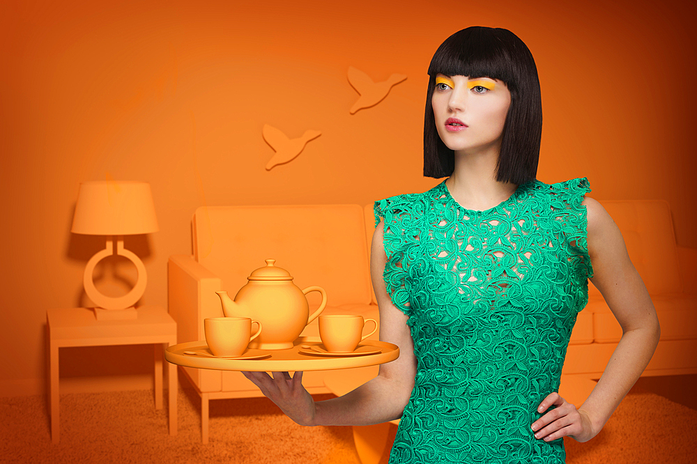 Caucasian woman in orange old-fashioned livingroom holding tea service