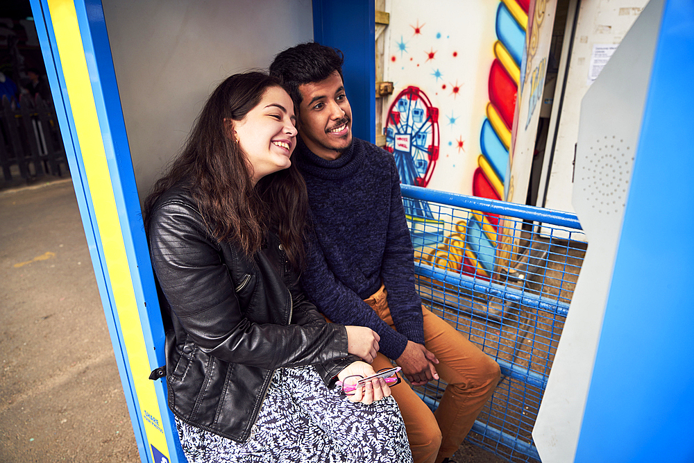 Couple posing in photo booth at amusement park