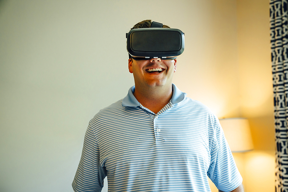 Caucasian man wearing virtual reality goggles