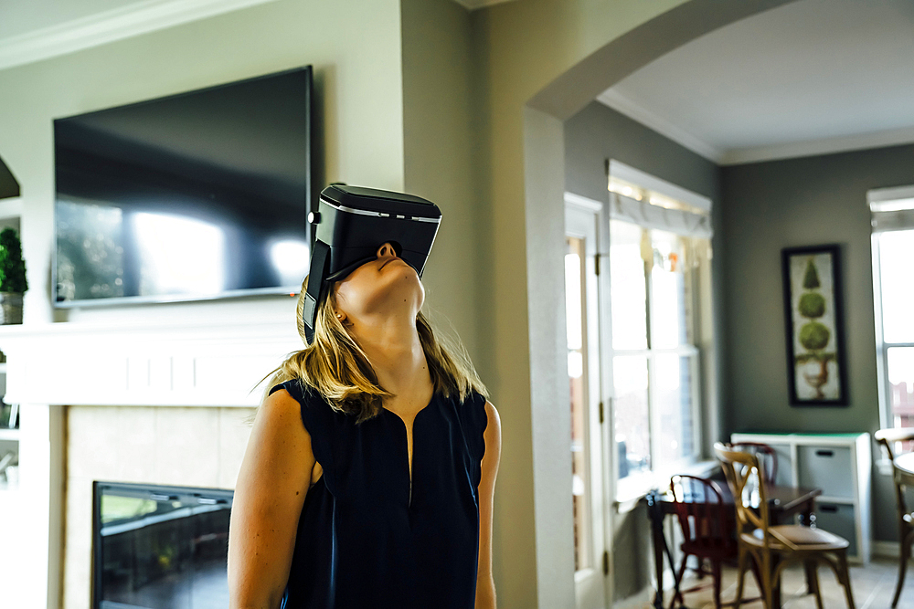 Caucasian woman wearing virtual reality goggles