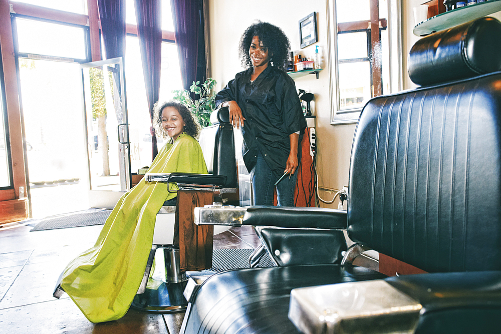 Smiling hairdresser and customer in hair salon