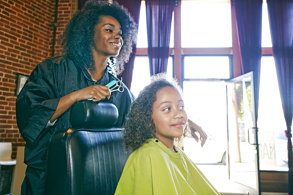 Smiling hairdresser and customer in hair salon