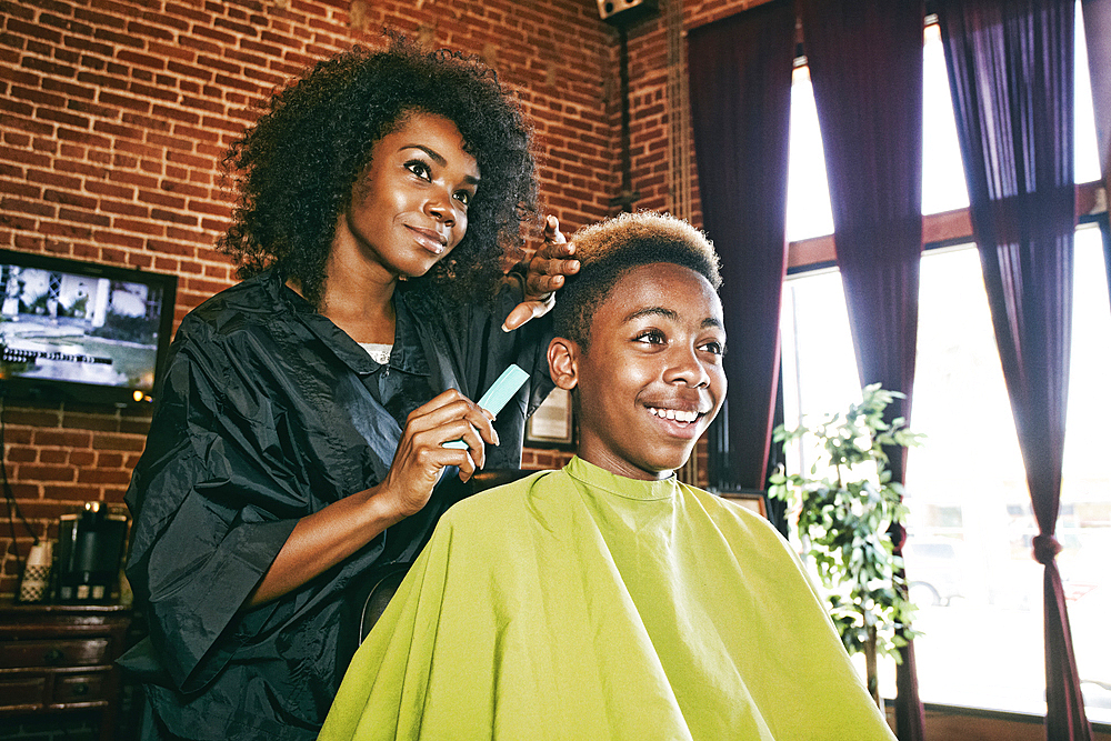 Smiling hairdresser and customer in hair salon