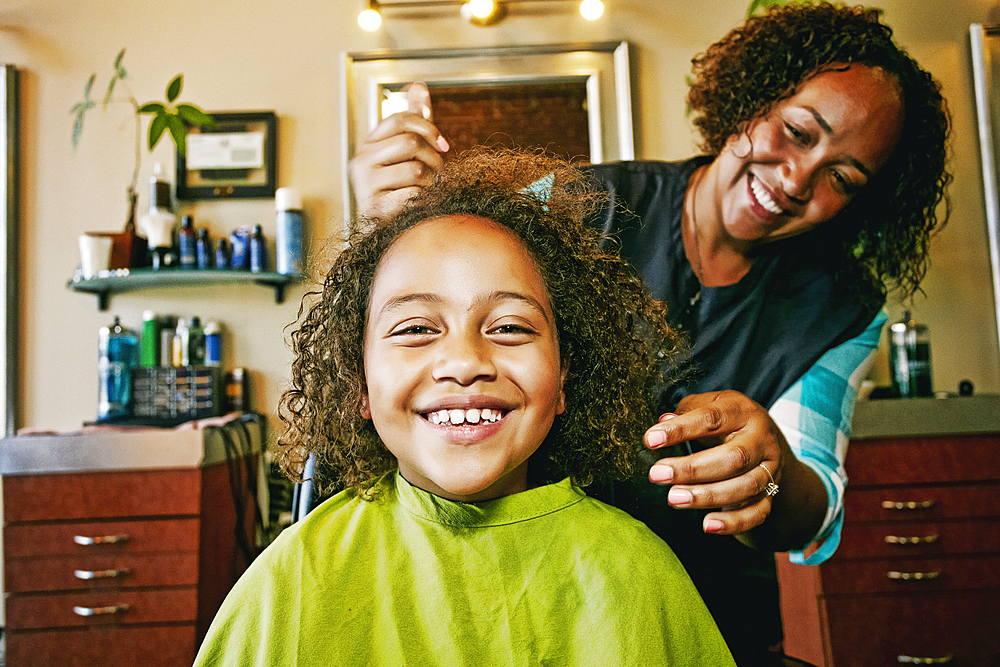 Smiling hairdresser and customer in hair salon