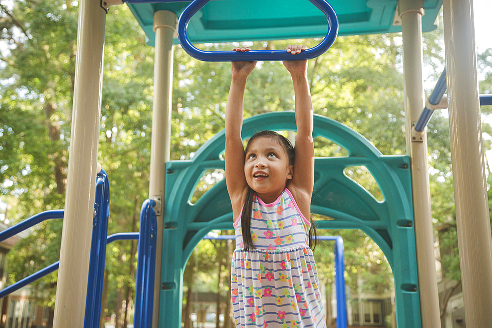 Hispanic playing on playground