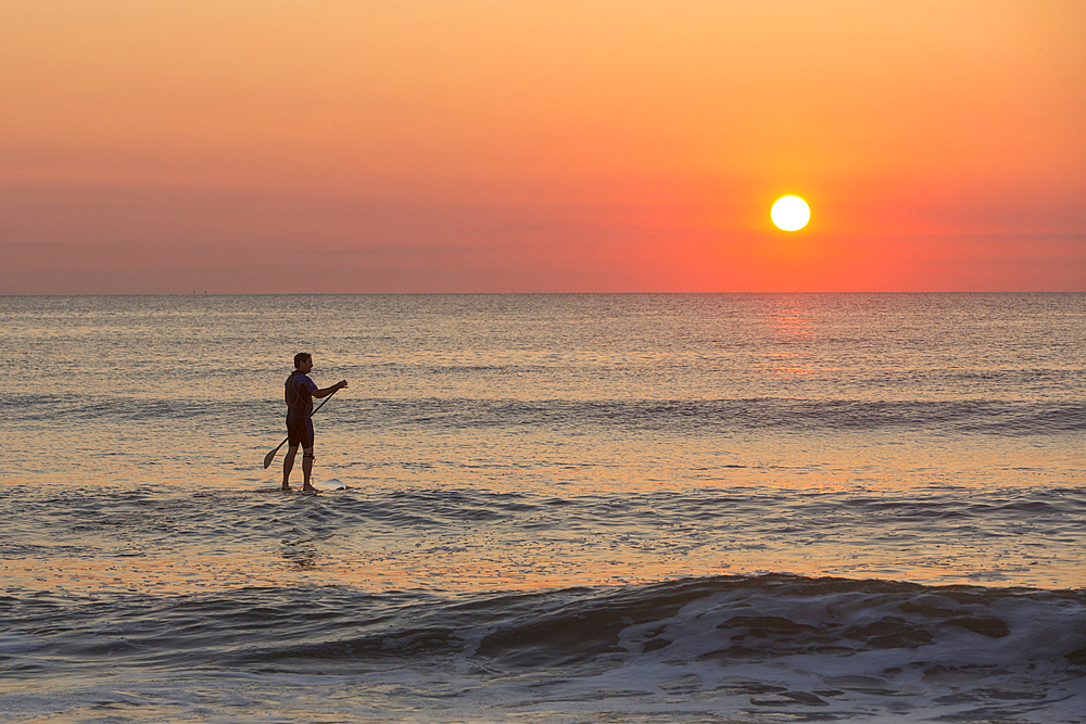 Silhouette of man on ocean