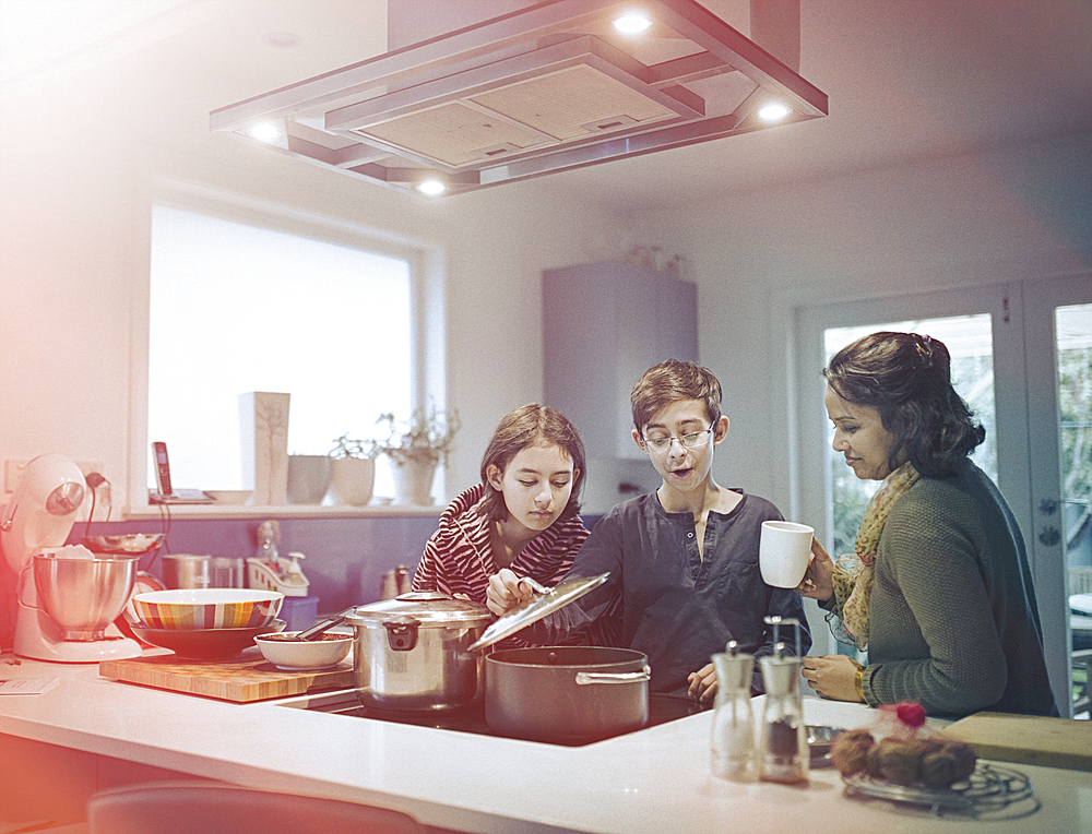 Family cooking food in kitchen