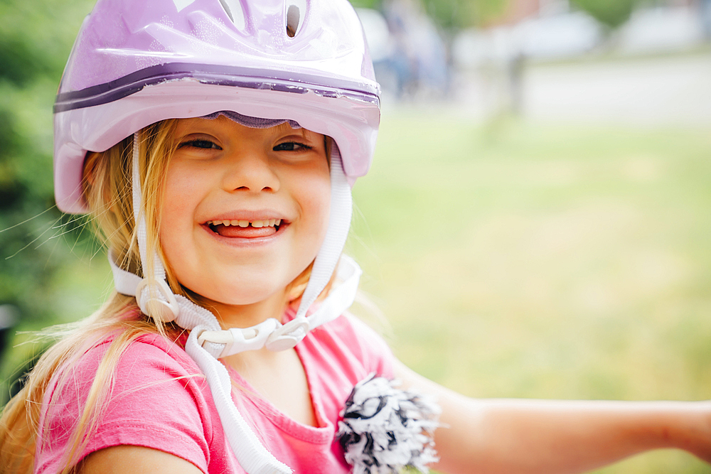 Smiling Mixed Race girl wearing helmet